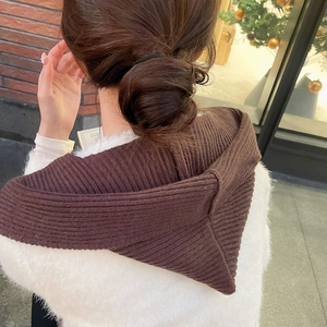 Detailed knit texture of coffee brown hooded scarf cowl on a woman during winter