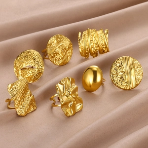 Set of seven gold adjustable rings with geometric textures and minimalist artistic design