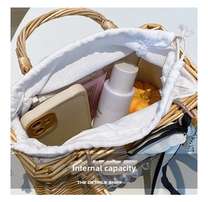 Top view of handmade woven basket bag showing spacious interior with phone and cosmetics