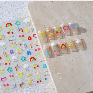 Detailed view of cute cartoon nail art stickers with rainbow and cherry relief patterns