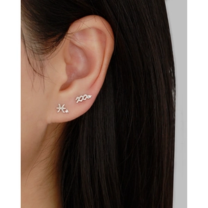 Close-up of S925 silver constellation piercing earrings with white zircon on ear