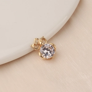Macro detail of gold-plated animal charm pendant with large sparkling zircon stone