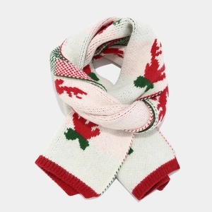 Detail of Christmas knitted scarf featuring festive red, green, and white reindeer patterns
