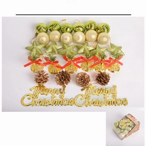 Macro display of 32-piece Christmas tree ornament set with gold bells and green baubles
