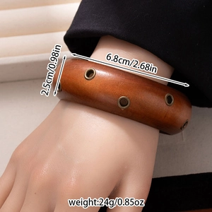 Detailed close-up showing wood grain texture and metal eyelets of the retro bangle