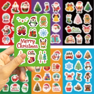 Close-up of DIY waterproof Christmas stickers featuring Santa and reindeer on vibrant paper
