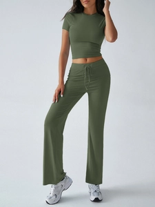 Detailed view of women's olive green short sleeve crop top and drawstring leisure pants