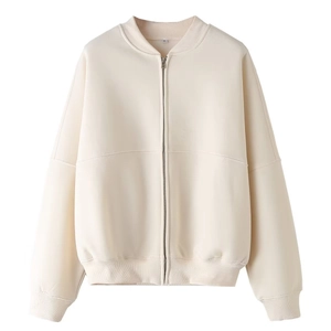 Detail of cream bomber jacket with ribbed collar, metal zipper, and XS size tag