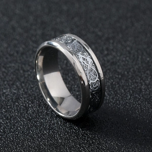 Detailed close-up of dragon pattern engraving on polished silver stainless steel ring