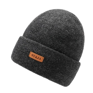 Deep grey winter knit beanie for men and women with leather patch on a white background