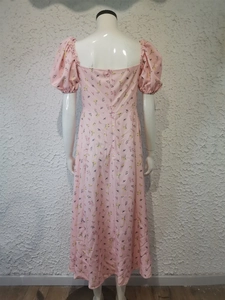 Close-up of pink floral dress featuring puff sleeves and square back cutout on mannequin