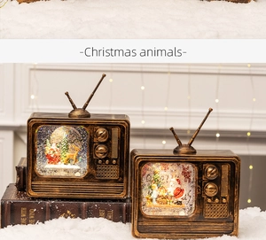 Vintage bronze TV music box with Santa scenes displayed on books with warm lights