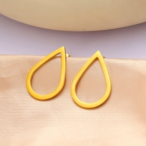 Macro shot of gold hollow water drop earrings with polished metallic finish and luxury detail