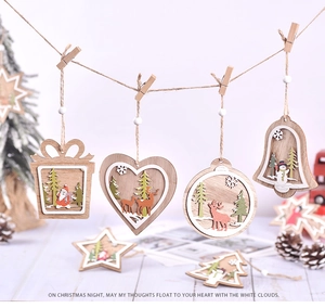 Detail of laser-cut wooden Christmas ornaments with 3D reindeer and Santa scenes