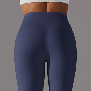 Detail view of high-waist yoga leggings showing V-shaped lifting seam and stretch fabric