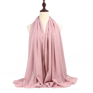 Detail of pink pearl chiffon hijab scarf showing soft texture and fluid drape on a mannequin
