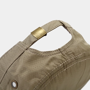 Detail of khaki military cap with honeycomb ripstop fabric and metal buckle
