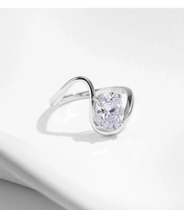 Macro shot of S925 sterling silver ring with oval clear gemstone and wavy band detail
