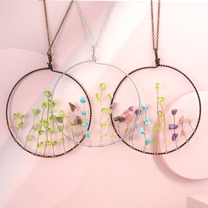 Detail of tree of life pendants with colorful natural crystal chips and copper wire