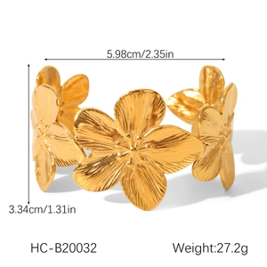 Detailed view of a gold floral open bangle with dimensions 5.98cm and weight 27.2g
