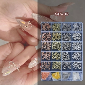 Macro view of 24-grid organizer with mixed metal nail art bows and colorful steel beads