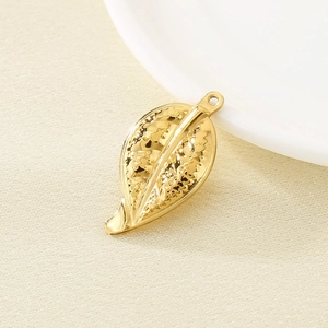 Close-up of golden leaf pendant with textured surface for DIY jewelry making