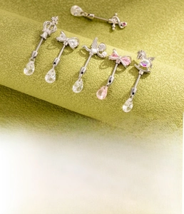 Detailed specs of titanium steel bow and crown ear studs showing 0.8mm/1.2mm gauge sizes