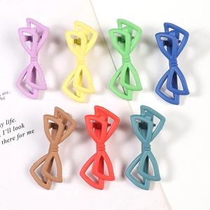 Flat lay of 8.3cm acetate rectangular hair claws in 7 macaron colors for women