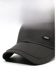 Close-up of a dark grey twill baseball cap brim with a metallic SPORT logo detail