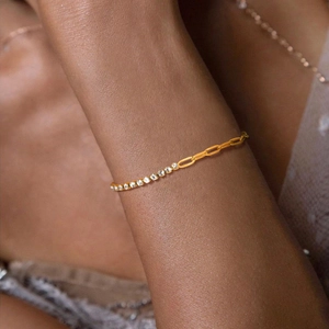 Golden stainless steel chain bracelet with square white zircons on a model wrist