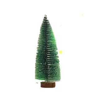 Miniature green Christmas tree with fake snow and wooden base for holiday table decor