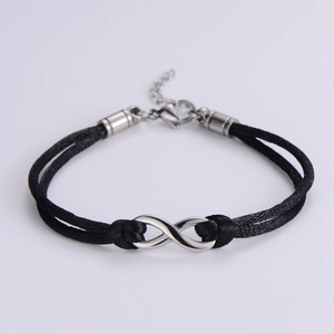 Detail of adjustable black braided rope bracelet with silver infinity symbol and clasp