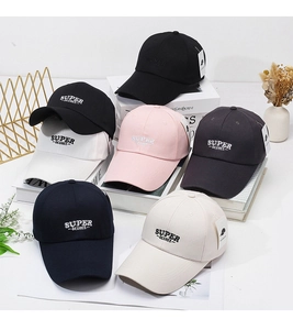 Detail of multi-color baseball caps with embroidered letters on a structured cotton crown