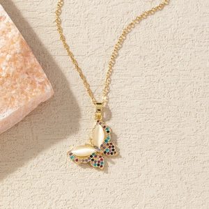 Detail of gold-plated butterfly necklace with colorful crystals and opal stones