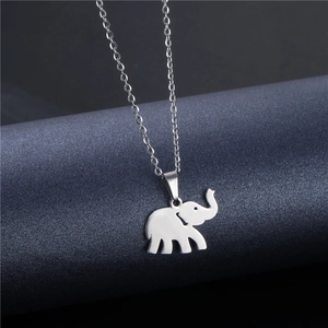 Polished stainless steel elephant pendant necklace on a dark minimalist background