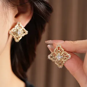 Elegant gold vintage hollow flower stud earrings with sparkling cubic zirconia crystals