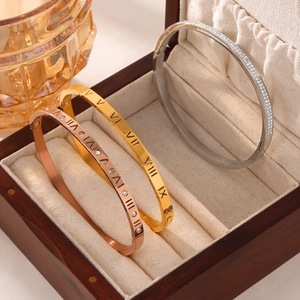 Three-piece roman numeral engraved bangles in gold, rose gold and silver finishes