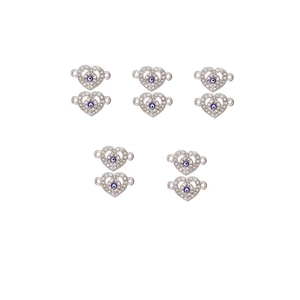 Macro detail of 10 heart-shaped Evil Eye alloy charms with blue zircons and silver finish
