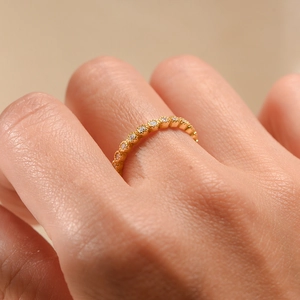 Close-up of gold s925 silver ring featuring delicate pavé-set shimmering zircon stones