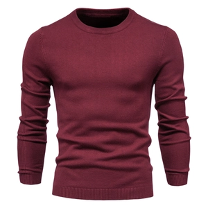 Close-up of wine red knitted sweater showing fine texture and crew neck detail