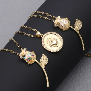 Three gold necklaces with rose and heart pendants featuring sparkling micro-pave zircons