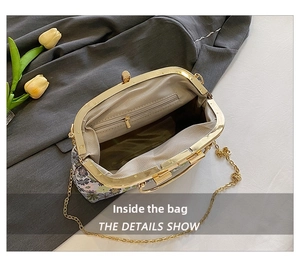 Internal view of floral embroidery bag with dual compartments and golden chain strap