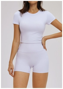 Detail of high-elasticity lavender yoga set showing slim-fit crop top and high-waist shorts
