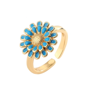 Detailed view of adjustable golden flower ring featuring vibrant blue enamel petals