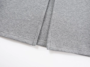Detailed close-up of gray knitted skirt showing fine stitching and premium fabric texture