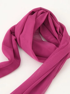 Detail of fuchsia mesh fabric showing breathable texture and flowing draping quality