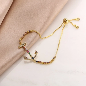 Detail of adjustable anchor bracelet with colorful micro-pave zircons on gold plating