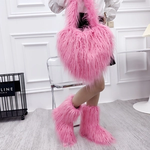 Detail of pink faux fur heart-shaped crossbody bag with matching plush winter boots