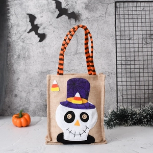 Detail of Halloween candy bag with skull applique and orange-black striped handle