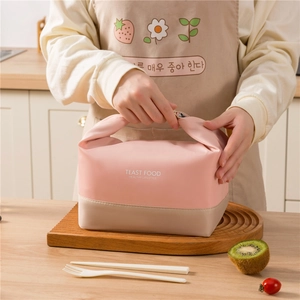 Pink insulated lunch bag with shoulder strap and healthy lifestyle lettering on wooden stand